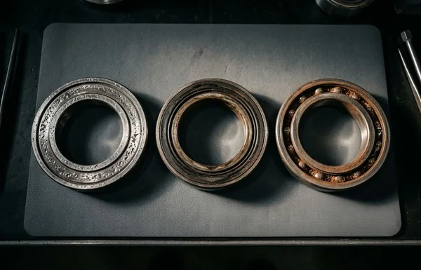 Disassembled bearing races showing regolith intrusion and race spalling